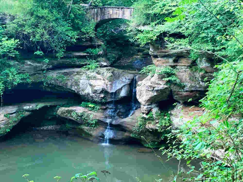 Waterfall over rocks into a pond of water