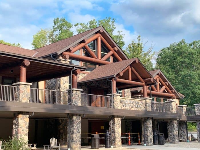 Stone and wooden two-story structure with the words Hocking HIlls State Park in the middle of the building